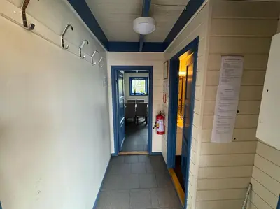 a hallway leading to a dining room in a building at Nautnes Coastal Haven in Nautnes