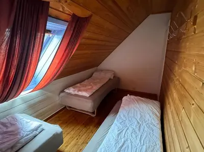 a small room with two beds and a window at Nautnes Coastal Haven in Nautnes