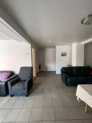 a living room with two chairs and a couch at Fishermans Apartment A13 in Nautnes