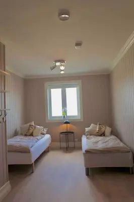 a room with two beds and a window at Villa Freya with stunning sea view in Kristiansund