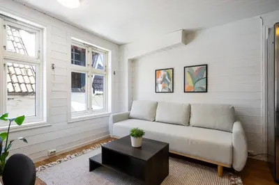 a living room with a couch and a table at City Center Apartment in Bergen