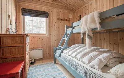 a bedroom with a bunk bed in a wooden room at 5 Bedroom Gorgeous Home In Engerdal in Nymoen