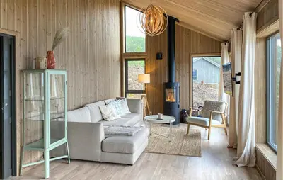 a living room with a couch and a table at 3 Bedroom Amazing Home In Åfarnes in Åfarnes