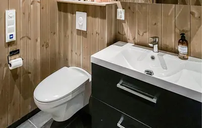 a bathroom with a white sink and a toilet at Cozy Home In Ålen With Wifi in Ålen