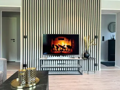 a living room with a fire place in the wall at Dalen Apartment in Stranda