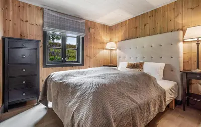 a bedroom with a large bed and a window at 4 Bedroom Gorgeous Home In Rauland in Rauland