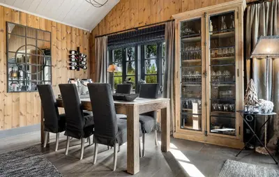 a dining room with a wooden table and black chairs at 4 Bedroom Gorgeous Home In Rauland in Rauland