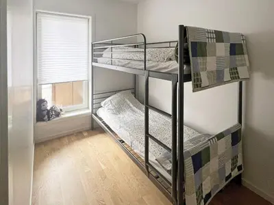 two bunk beds in a room with a window at 4 person holiday home in Frekhaug in Hordvik