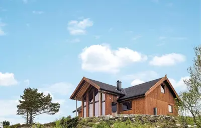 a wooden house on top of a hill at Awesome Home In Sveio in Sveio
