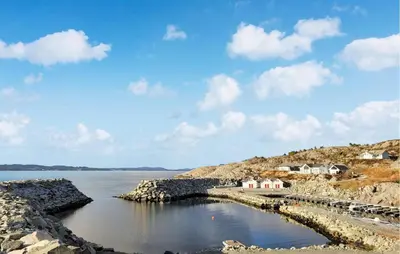 a body of water with houses on the shore at Awesome Home In Sveio in Sveio