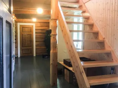 a staircase in a log cabin with a wooden stair case at Newly renovated house on a farm in Berge