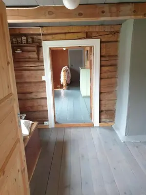 a room with wooden walls and a hallway with a doorway at Newly renovated house on a farm in Berge