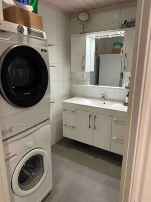 a kitchen with a washing machine and a sink at Geilo Kikut - Ski-in Ski-out in Geilo