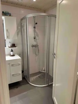 a shower with a glass door in a bathroom at Geilo Kikut - Ski-in Ski-out in Geilo