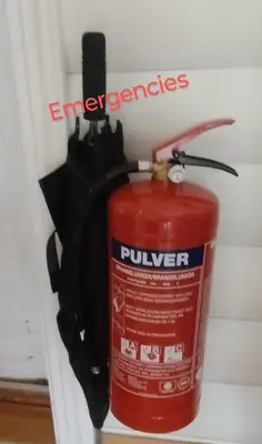 a red fire extinguisher sitting on a wall at Sleep Over in Eiknes