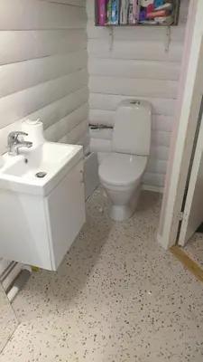 a bathroom with a white toilet and a sink at Sleep Over in Eiknes