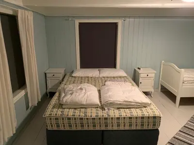 a bedroom with two beds and two night stands at Rikstaddal in Kalvhagen