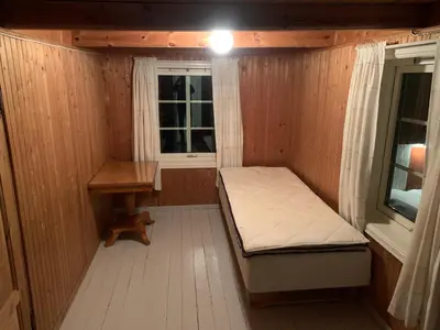 a small room with a bed and a desk at Rikstaddal in Kalvhagen