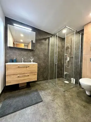 a bathroom with a shower and a sink and a toilet at Vika Minihouse in Kristiansund