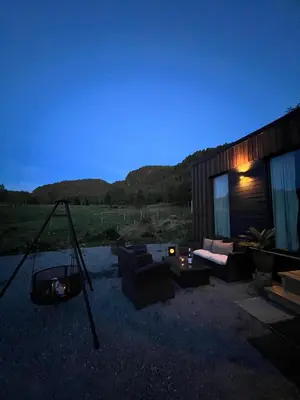 a living room with a couch and a swing at Vika Minihouse in Kristiansund