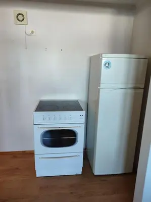 a white stove and a refrigerator in a kitchen at Biri nær Gjøvik ,Hamar og Lillehammer apartments in Gjøvik