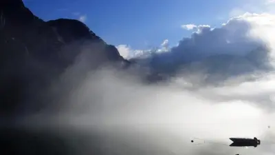 a plane flying through the clouds in the sky at Fjordhytte-4 nahe Trolltunga, Hardanger, direkt am Maurangerfjord in besonders attraktiver Umgebung in Sundal
