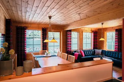 a living room with a table and a dining room at Fjordhytte-4 nahe Trolltunga, Hardanger, direkt am Maurangerfjord in besonders attraktiver Umgebung in Sundal