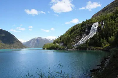 a view of a mountain lake with a waterfall at Fjordhytte-7, im Vestland, am Maurangerfjord beim Hardanger, nahe Trolltunga, zwischen Odda und Rosendal in Sundal