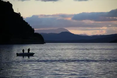 two people on a boat in the water at Fjordhytte-7, im Vestland, am Maurangerfjord beim Hardanger, nahe Trolltunga, zwischen Odda und Rosendal in Sundal