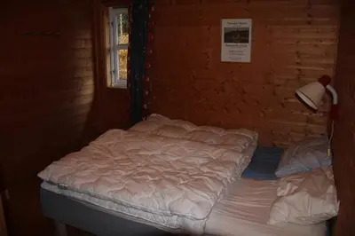 a bed in a room with a brick wall at Fjordhytte-40 im Vestland - Hordaland nahe Rosendal in Rosendal