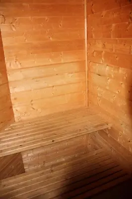 a wooden sauna with a bench in the corner at Fjordhytte-40 im Vestland - Hordaland nahe Rosendal in Rosendal