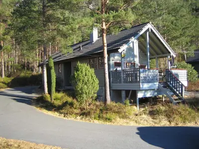 a small house with a porch on the side of a road at Fjordhytte-40 im Vestland - Hordaland nahe Rosendal in Rosendal