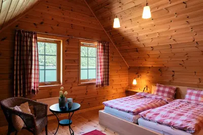 a bedroom with two beds in a log cabin at Fjordhytte-5 Hardanger-Region, zwischen Odda und Rosendal in Sundal