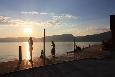 a group of people standing on a dock in the water at Fjordhytte-16 direkt am Sognefjord in Bjordal, mit mietbaren 9,9 PS bis 60 PS Motorbooten in Bjordal