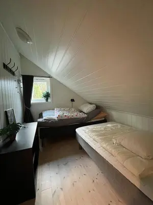 a room with two beds and a window at Fjordhytte-13 in Ænes
