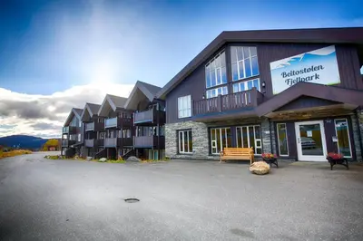 a large building with a bench in front of it at Charming Top Floor Apartment With Balcony in Beitostøl
