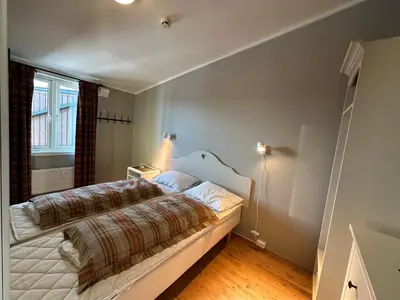 a bedroom with a bed and a window at Charming Top Floor Apartment With Balcony in Beitostøl