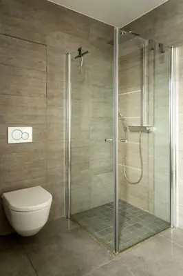 a bathroom with a toilet and a glass shower at Fjord-view apartment in Ålesund