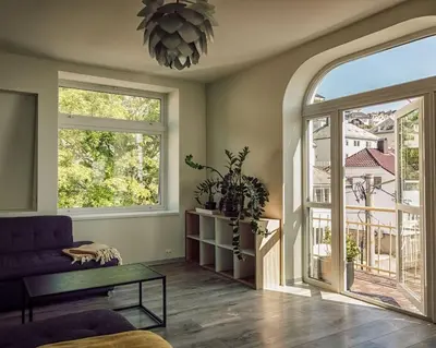 a living room with a couch and a large window at Fjord-view apartment in Ålesund