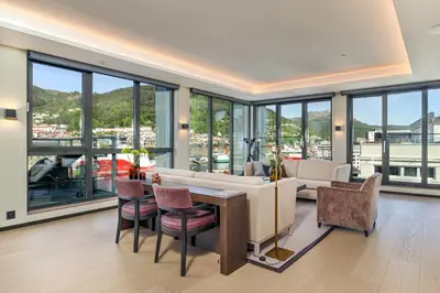 a living room with a couch and a table and chairs at Nordnes Brygge in Bergen