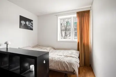 a bedroom with a bed and a window at Studio in the city centre in Trondheim