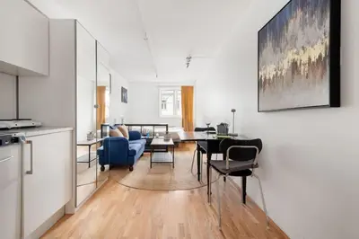 a kitchen and living room with a table and chairs at Studio in the city centre in Trondheim