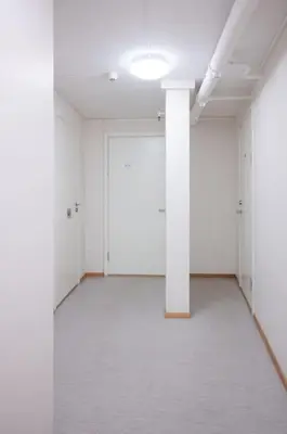 an empty room with white walls and a white pillar at Studio in the city centre in Trondheim