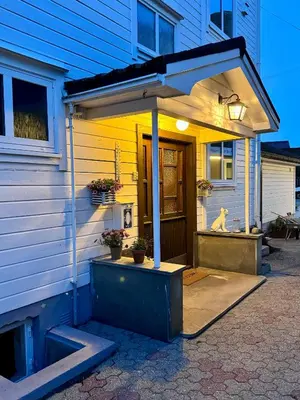 a house with an awning on the front of it at Villa Utsikten Kirketaket in Åndalsnes