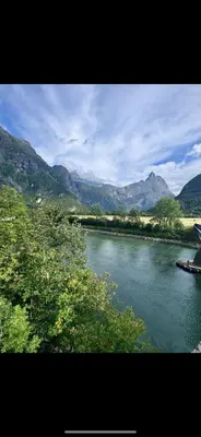 a view of a river with mountains in the background at Villa Utsikten Kirketaket in Åndalsnes