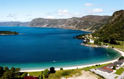 an aerial view of a beach in a body of water at Doktorgarden in Selje