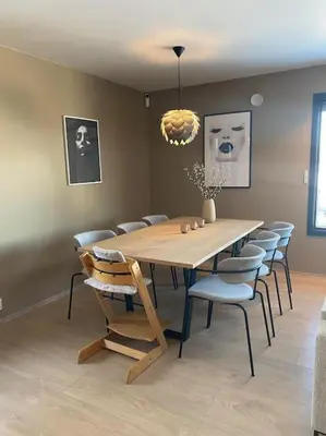 a dining room with a wooden table and chairs at Utsikten in Lillehammer