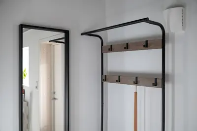 a mirror on a wall next to a window at KS Apartment Modern & cozy flat 20 min from Bergen centre in Espeland