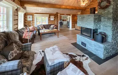 a living room with a couch and a fireplace at Beautiful Home In Øyer With Wifi in Øyer