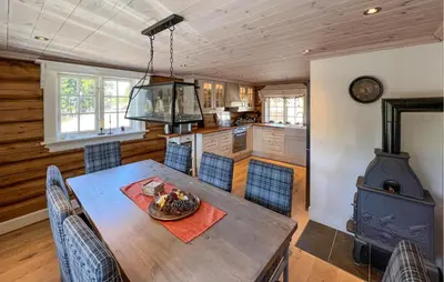 a kitchen and dining room with a table and a stove at Beautiful Home In Øyer With Wifi in Øyer